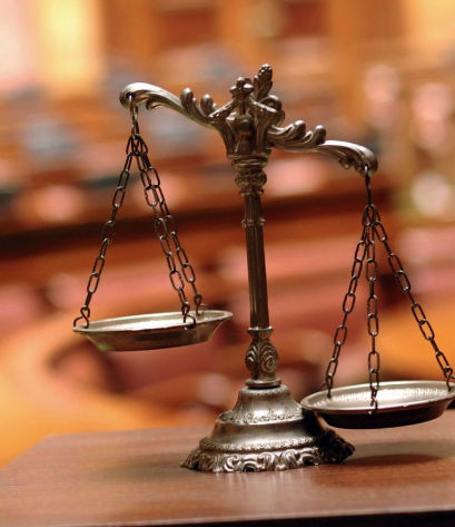 Law scale with Insurance Coverage books in the background at a Los Angeles attorney's office 