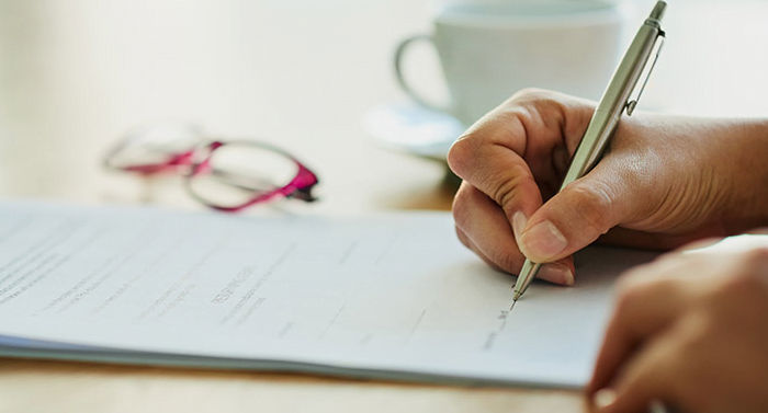 Client signing Insurance Coverage documents at a Los Angeles attorney's office